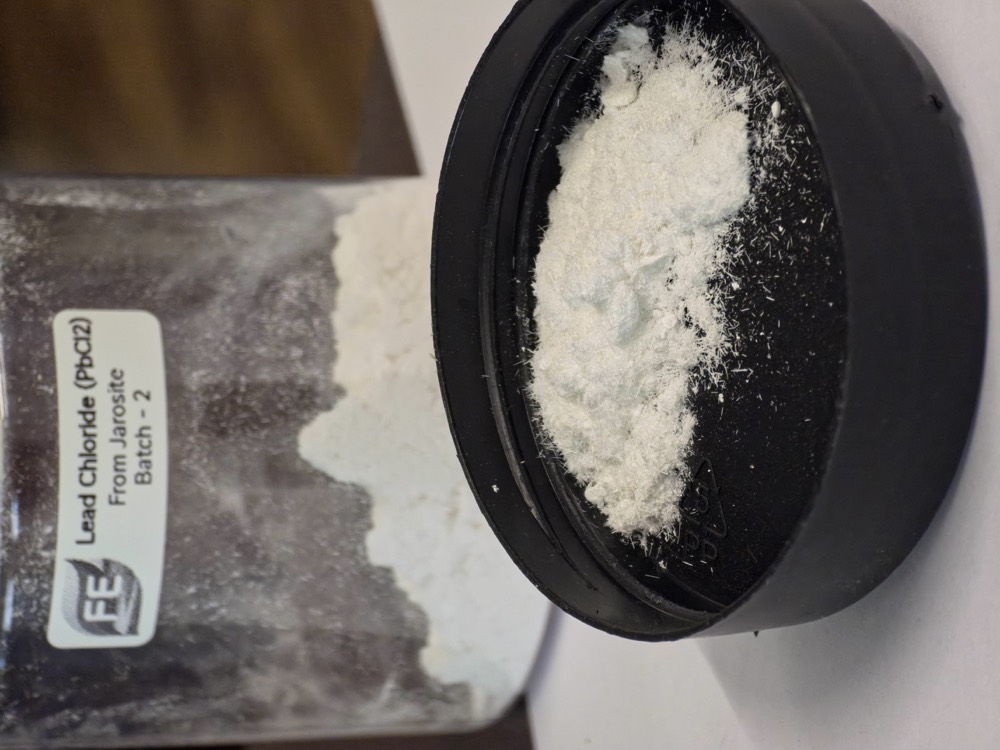 Lead chloride crystals recovered from jarosite, in a labelled specimen jar