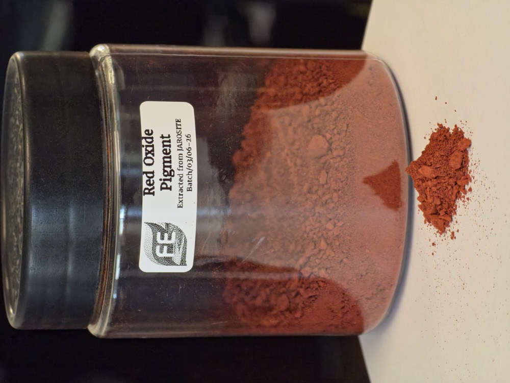 Red oxide pigment recovered from jarosite, in a labelled specimen jar