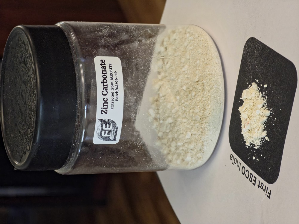 Zinc carbonate powder recovered from jarosite, in a labelled specimen jar